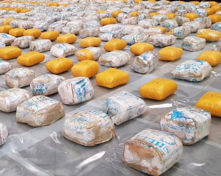 Rows of packaged heroin laid out on the floor
