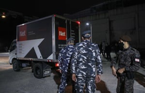 Members of Lebanese security forces stand next to a truck transporting boxes of the first shipment of the Covid-19 Pfizer-BioNTech vaccine upon arrival to the Rafic Hariri University Hospital in the capital Beirut, on 13 February, 2021.