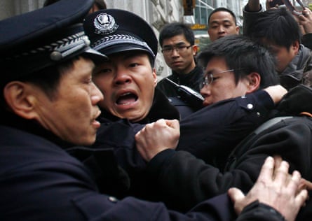 Police arrest a man after internet social networks called to join a ‘Jasmine revolution’ protest in Shanghai, in February 2011.