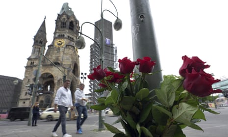 Kaiser Wilhelm memorial church  and roses next to a lamp post