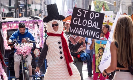 A man dressed as a snowman participates in the march to end fossil fuels.