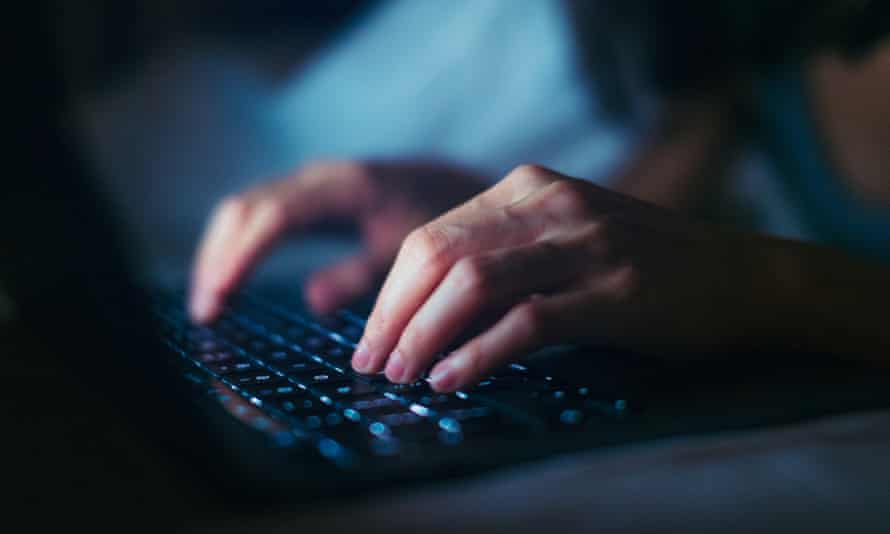 Close-up shot of hands typing on computer keyboard