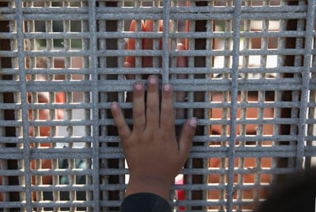 Family members are separated by a fence at the US-Mexico border in San Diego, California, in 2013.