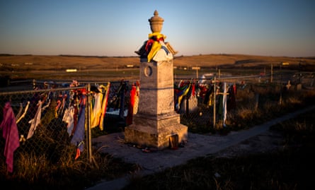 Peace offerings of tobacco ties line the fence at the Wounded Knee Memorial on Pine Ridge Reservation in South Dakota.