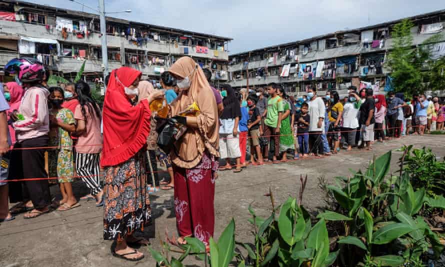 People queue to buy cooking oil in Palembang, Indonesia