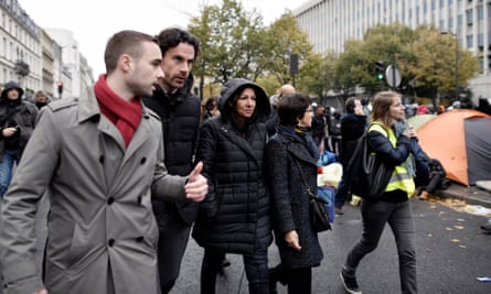 The mayor of Paris, Anne Hidalgo (centre), arrives during clearance of the camp in Paris