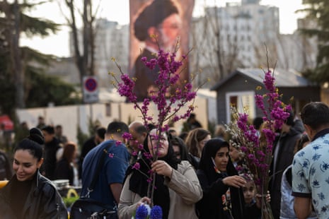 People shop for flowers at a market ahead of Nowruz celebrations on 19 March 2026 in Tehran, Iran.