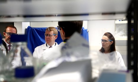 Jacinda Ardern, right, and Covid minister Chris Hipkins visit a lab at Auckland University.