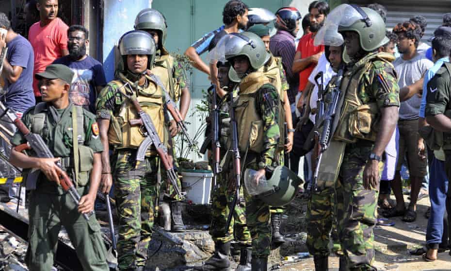 Sri Lankan troops patrol on the streets of Pallekele, a suburb of Kandy.