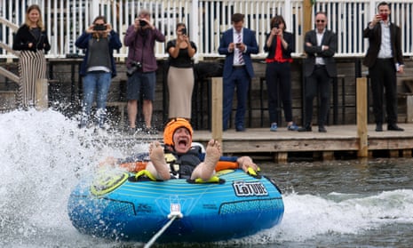 British leader of the Liberal Democrats party Ed Davey attends a general election campaign event, in CotswoldsBritish leader of the Liberal Democrats party Ed Davey reacts as he rides a towable inflatable during a visit to Lakeside Ski & Wake, in Cotswolds, Britain, July 1, 2024. REUTERS/Hollie Adams