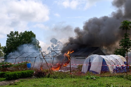 Flames and smoke rise from an Ebola treatment centre in Rwampara.