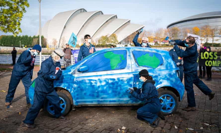 Activists from Extinction Rebellion took part in a ‘Loss and Damage’ protest performance where a car painted to look like a globe was smashed to highlight inequity of loss and damage when it comes to the climate crisis at Pacific Quay alongside the Cop26 summit campus in Glasgow.