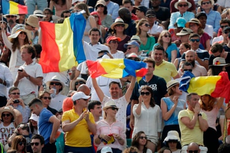 Spectators hold Romanian flags