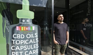 Gus Dabais stands in front of his Sidewalk Wellness store in San Francisco, where CBD oil products are popular items.