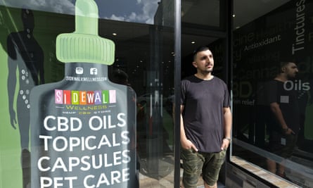 Gus Dabais stands outside his Sidewalk Wellness store in San Francisco, where CBD oil-infused products are popular items.