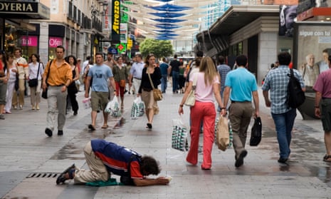 A man begs for money in Madrid.