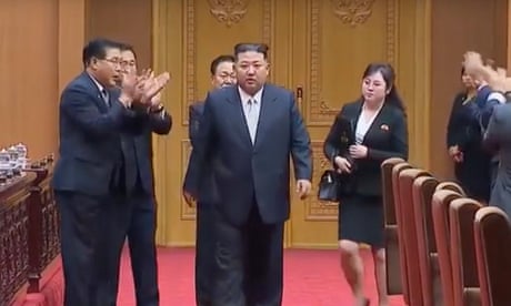 Kim Jong-un, with the mystery woman behind him