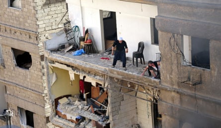 Residents of a building damaged by a car bomb in Jaramana, greater Damascus.