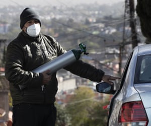 Ricardo Ledesma Carrasco gets into his car after refilling a tank of oxygen at a store for his dad who is being treated for Covid-19 at home in Mexico City. Carrasco’s mother also has Covid-19.
