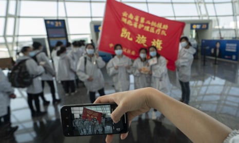 Medical staff drafted in from Yunnan province to tackle the coronavirus outbreak pose for a photo at Wuhan airport.