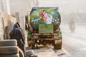 The back of a green truck depicting a man and woman on a large swing