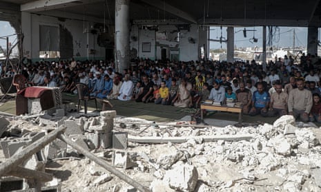 People perform the absentee funeral prayer for Sinwar at a destroyed mosque in Khan Younis, southern Gaza, on Friday
