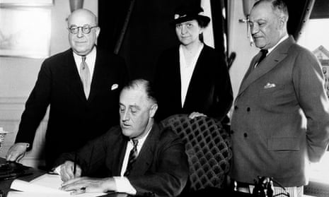 On 6 June 1933, Franklin D Roosevelt signs a bill at the White House. Frances Perkins, secretary of labor, stands behind the president.