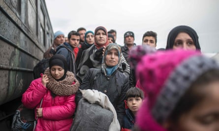 Migrants and refugees board a train heading to Serbia from the Macedonian-Greek border
