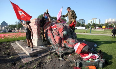 A defaced statue of Queen Victoria lies after being toppled during a rally on Canada Day in Winnipeg