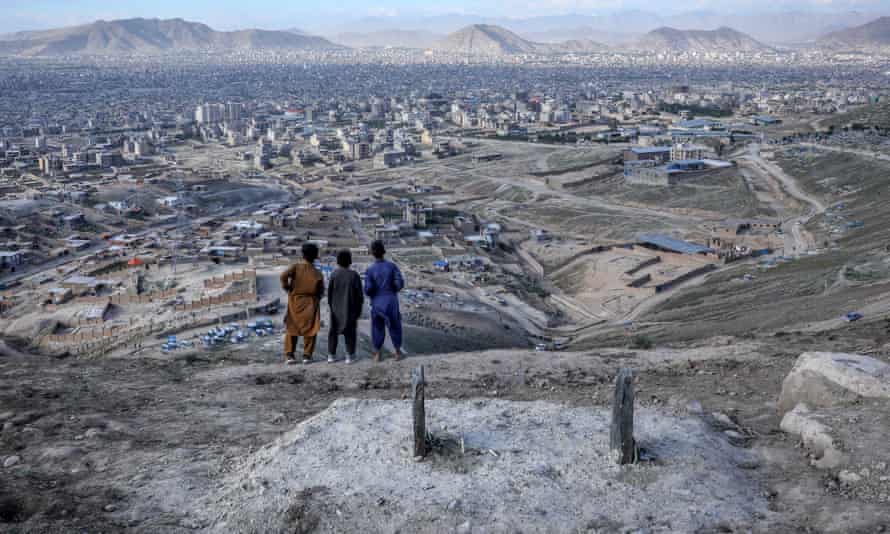 Afghan children by a grave of a victim of the recent attack on Sayyid al-Shuhada school in west Kabul.