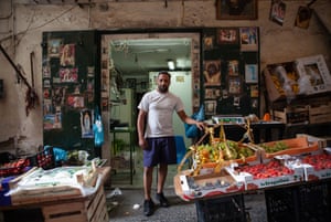 A neighborhood greengrocer in front of his family’s historic shop in the Quartieri Spagnoli. Holy prayer cards, icons, sacred statues and paintings have been a constant presence in the poorer districts of the city.