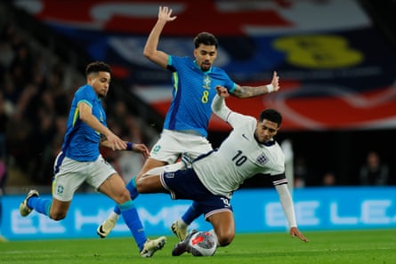 Brazil’s Lucas Paquetá fouls Jude Bellingham
