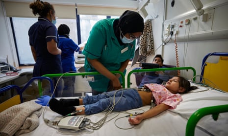 Zunaira is given an electrocardiogram by nurse Shaima Youssuf before she and her brother Zain are given lumasiran in a clinical trial at Great Ormond Street Hospital, Lomndon.