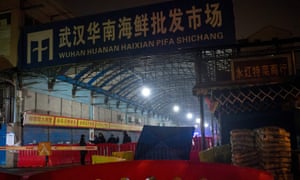 This photo taken on 11 January 2020 shows security guards in front of the closed Huanan Seafood Wholesale Market in Wuhan, in central China’s Hubei province.
