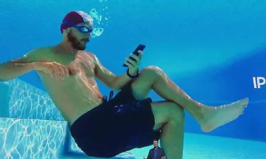 A Samsung ad shows a person using their phone underwater. The Australian Competition and Consumer Commission claims Samsung’s ads claiming water resistance were incorrect. 
