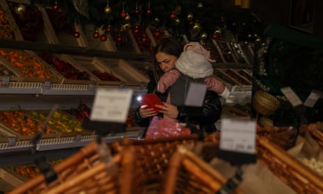 Locals buy food at a shopping centre during a blackout in Kharkiv, Ukraine.