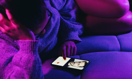 Woman lies on sofa swiping and liking profiles on dating app on phone. 
