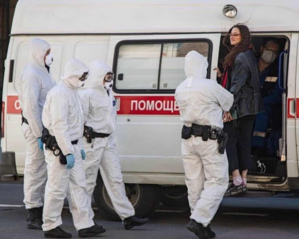 Rita Flores being escorted into a van by Russian security services