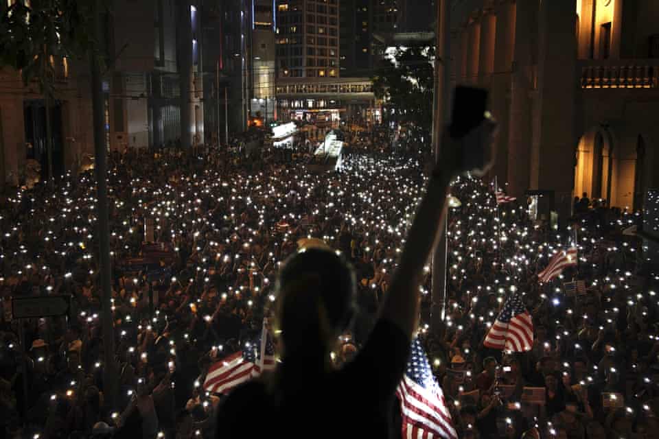 Protesters light torches during a peaceful rally in central Hong Kong’s business district, 14 October.