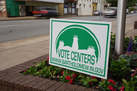 A green and white sign declaring “vote centers” stands in a flower bed outside the Bartholomew county governmental office building in Columbus, Indiana