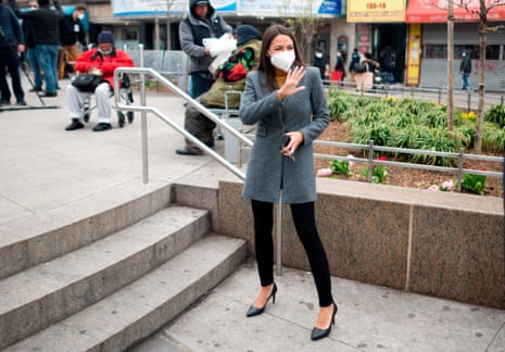 Alexandria Ocasio-Cortez wears a face mask for protection against the coronavirus, as she arrived for a press conference yesterday in New York, alongside Senate Minority Leader and fellow New Yorker Chuck Schumer.
