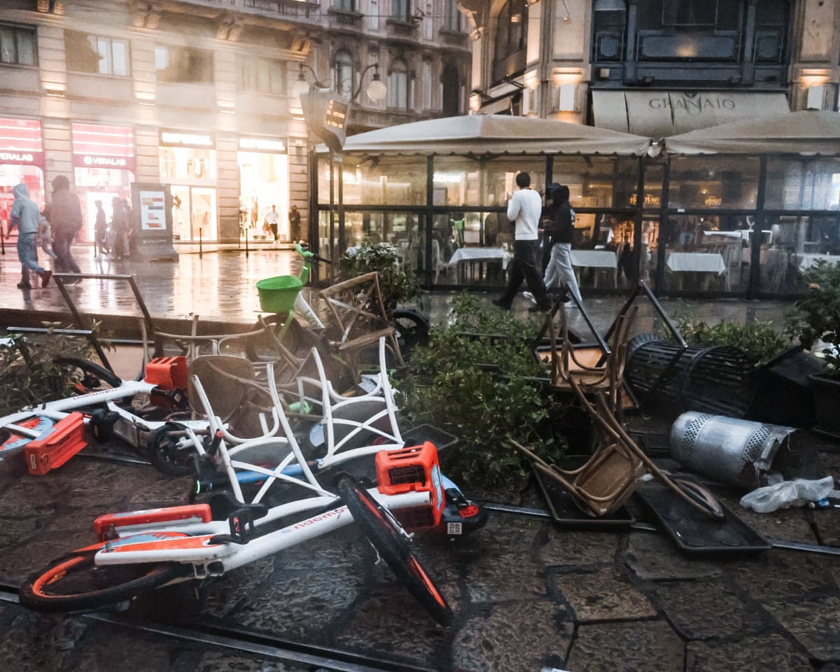 Overturned bicycles, chairs and debris litter Piazza del Duomo in Milan after a protest