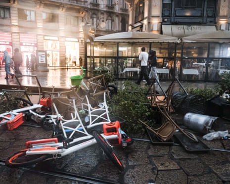 Overturned bicycles, chairs and debris litter Piazza del Duomo in Milan after a protest