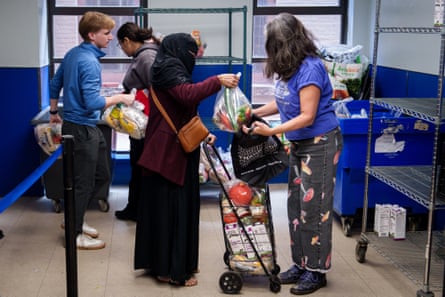 A person putting food in a basket.