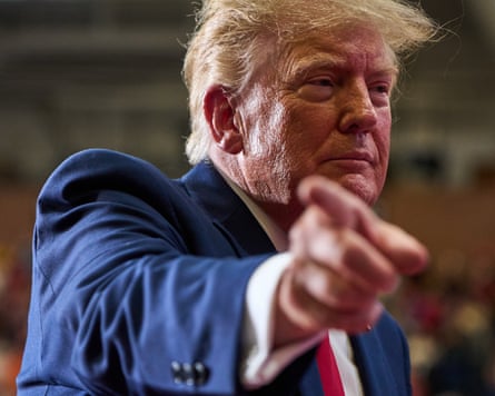 Donald Trump points directly at the camera while departing a campaign rally