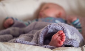 A baby sleeping in a basket