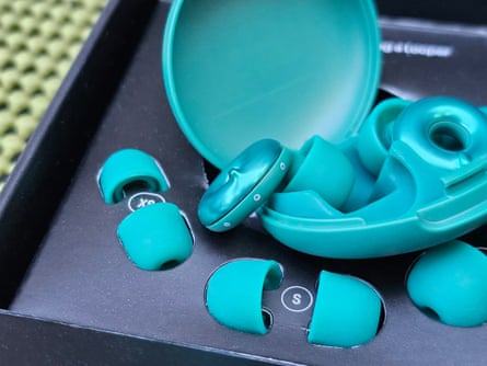 close-up of teal-colored Loop Switch 2 earplugs inside box