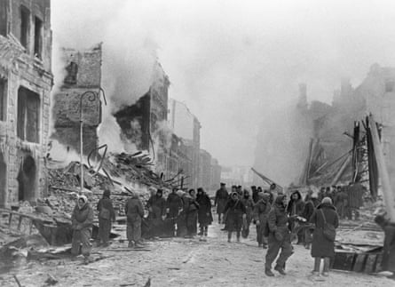 Citizens of Leningrad clear away ruins and extinguishing fires after Nazi bombardments.