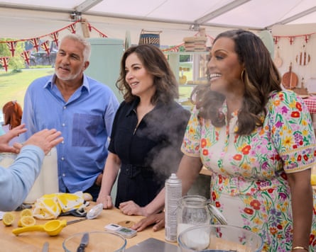 Paul Hollywood, Nigella Lawson and Alison Hammond stand in The Great British Bake Off tent, speaking to a competitor who is out of frame.