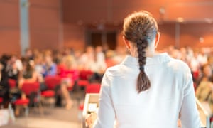 A female academic gives a lecture to students